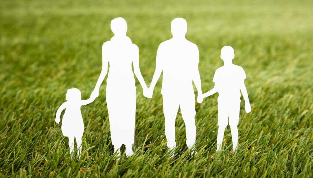 Family Papercut On Grassy Field