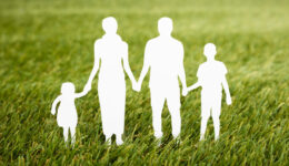 Family Papercut On Grassy Field